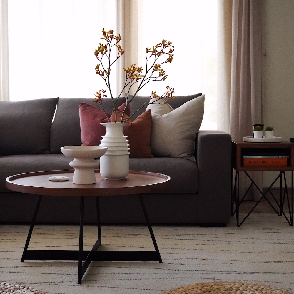 Inviting living room interior with layered rugs, soft lighting, and curated furniture by Roberts Renovations.