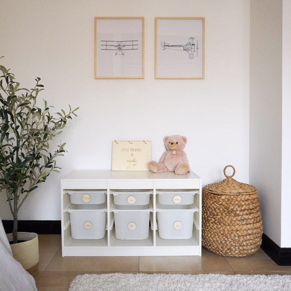 Smart storage area with organised shelving and wooden boxes in aeroplane-themed boys’ bedroom by Roberts Renovations.