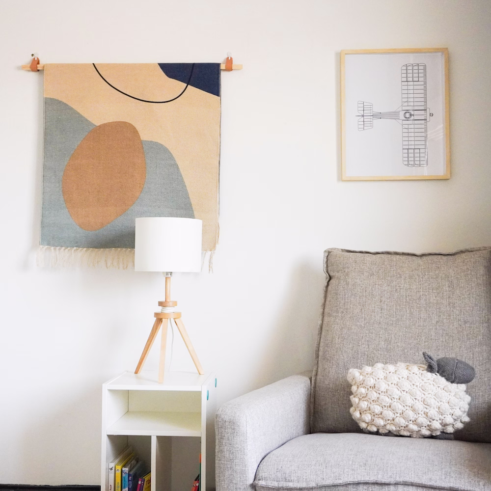 Cosy sitting area with soft cushions and warm tones in playful aviation-inspired boys’ bedroom.