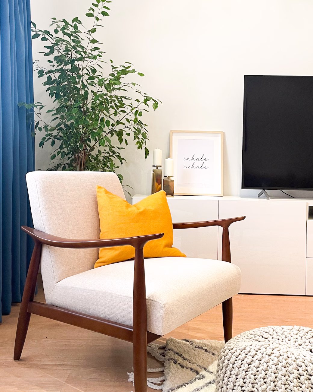 Family room with colourful accessories, soft furnishings, indoor plants, and artwork by Roberts Renovations.