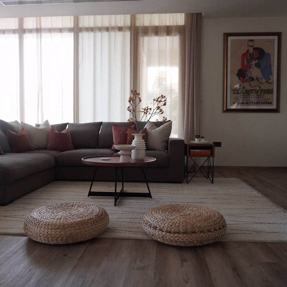 Contemporary second living room interior designed by Roberts Renovations, featuring neutral tones, comfortable seating, and layered textures for a relaxed and elegant feel.