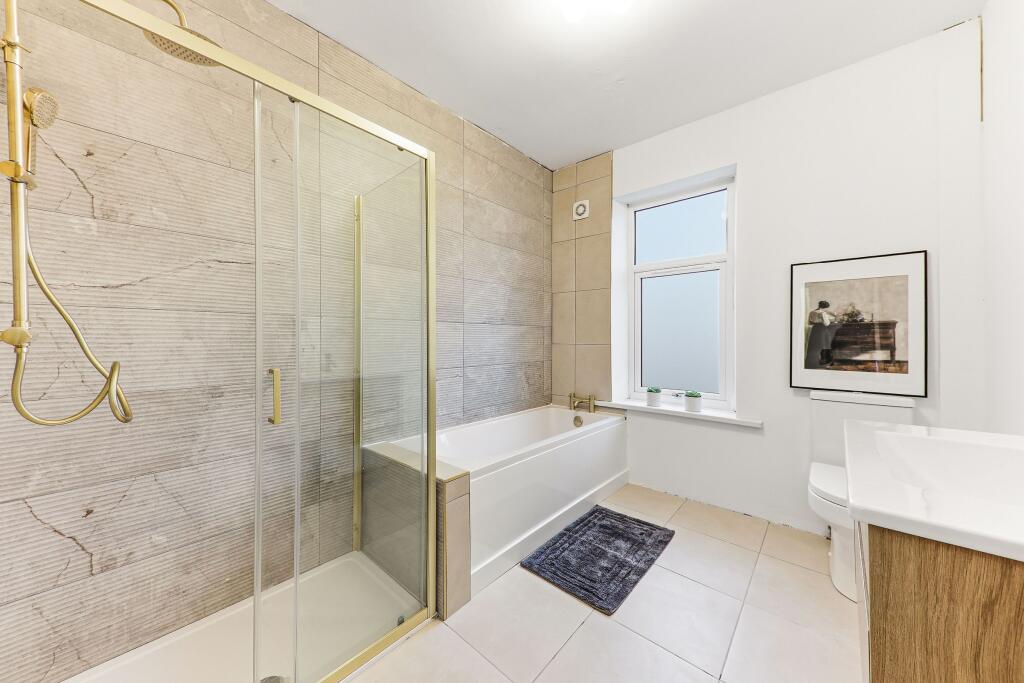 Master bathroom renovation in Pudsey buy-to-let property with bath, shower screen and gold fittings