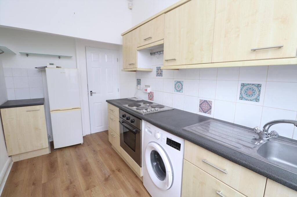 Before renovation kitchen in Pudsey buy-to-let property showing original cabinetry and appliances