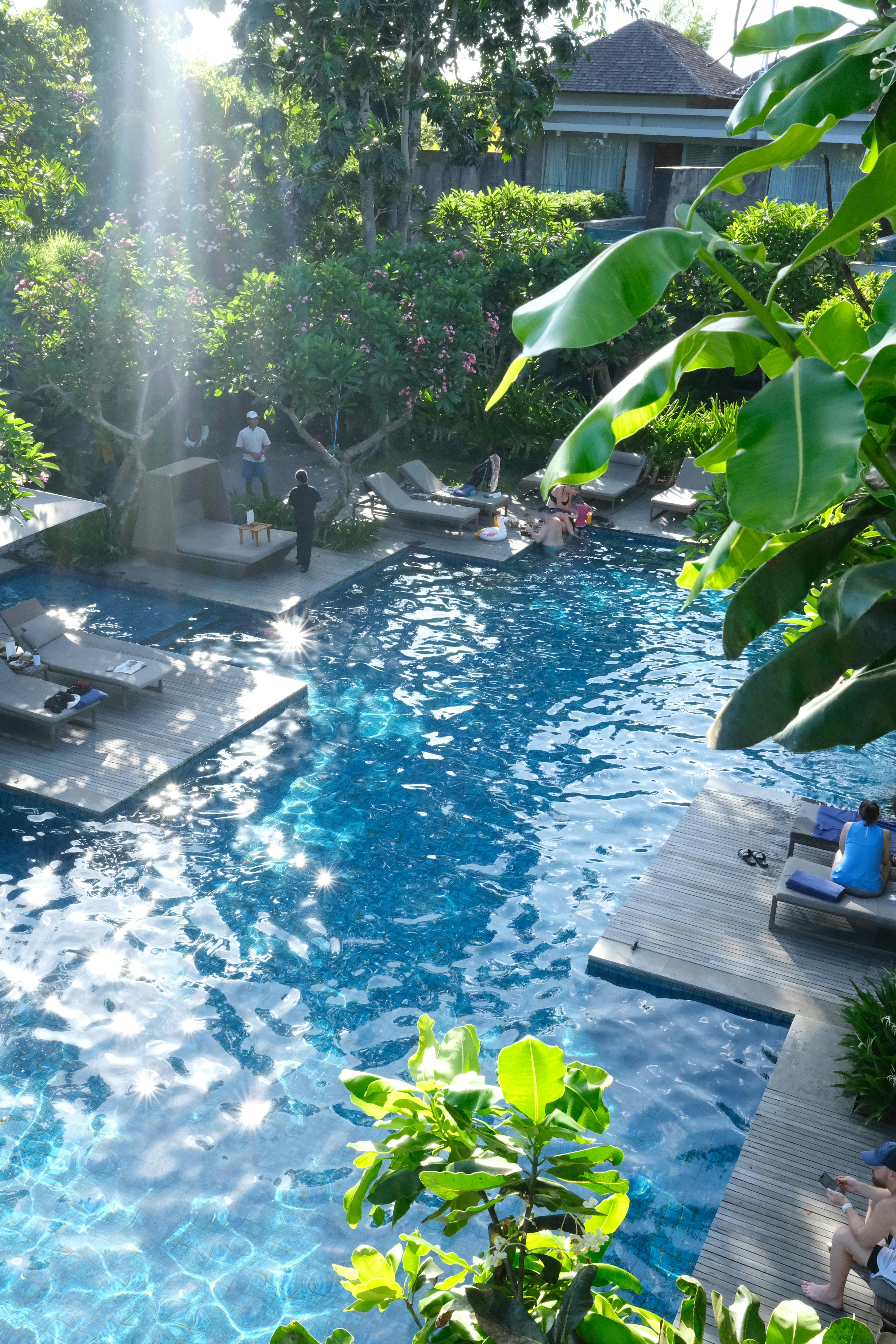 a high up shot of a pool inspector and other people around a poot