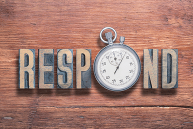 The word RESPOND spelled out with vintage letterpress blocks and a stopwatch in place of the letter O, all on a wooden background.