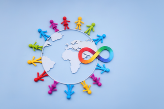 Colorful pushpins form a globe around a world map, with a red-and-blue infinity symbol overlay at the center on a light blue background.