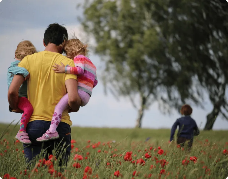 Man holding child in the field