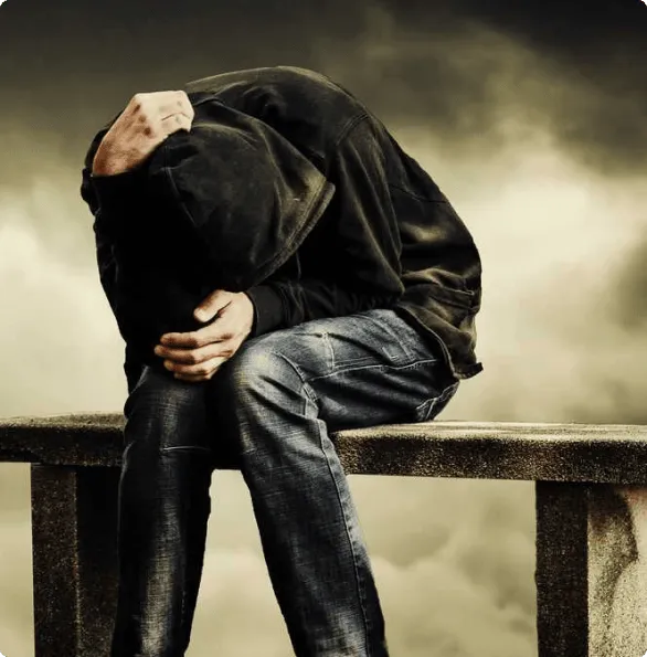 Man sitting with face in his hands