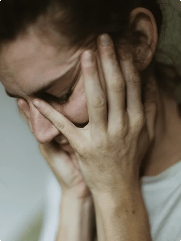 Woman with her face in her hands