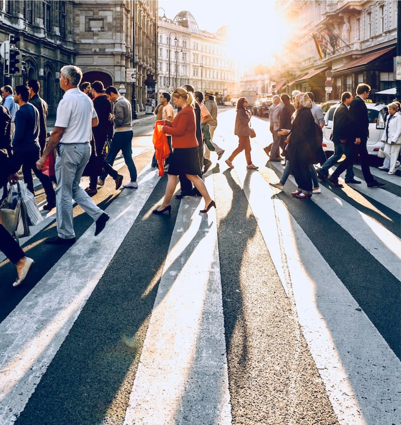 People walking in the crosswalk on a busy street