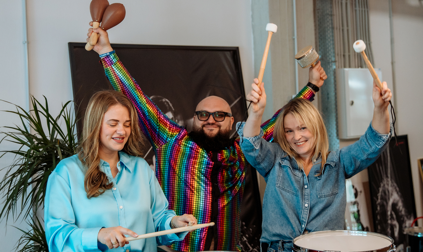 Muse Group employees enjoying a team building session with percussion instruments