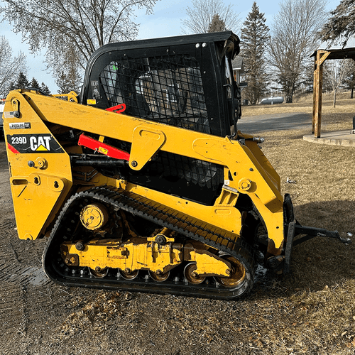 A CAT 239D: Track Loader outside on a farm ready to use and rent with NHR Rentals