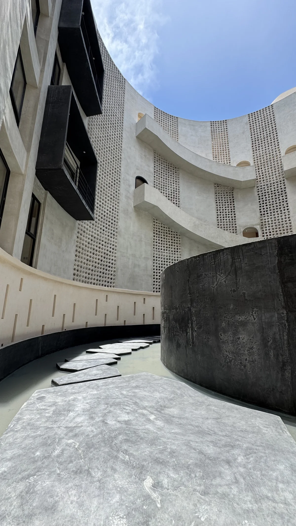 Image of a Modern Architecture, featuring Brutalist Design and Curved Facade.