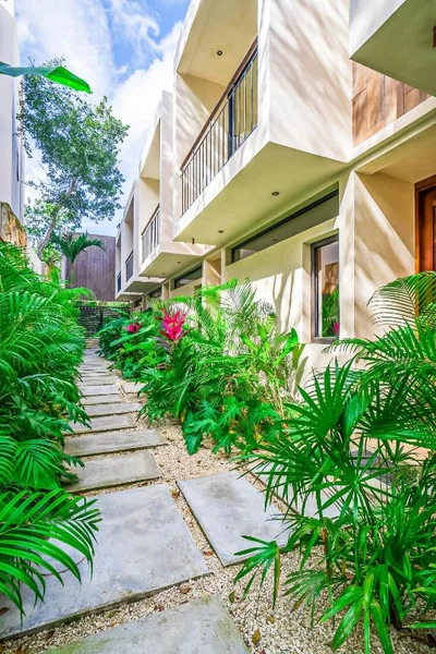 Image of a Lush Tropical Garden, featuring Modern Architecture and Private Balconies.