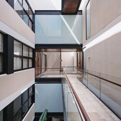 Image of a Modern Architectural Design, featuring Multi-Level Atrium and Glass Skybridge.
