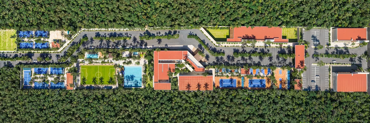 Image of a Extensive Sports Facilities, featuring Aerial View and Lush Jungle Setting.