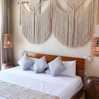 Image of a Bohemian Style Bedroom, featuring Macrame Wall Decor and Hardwood Bed Frame.