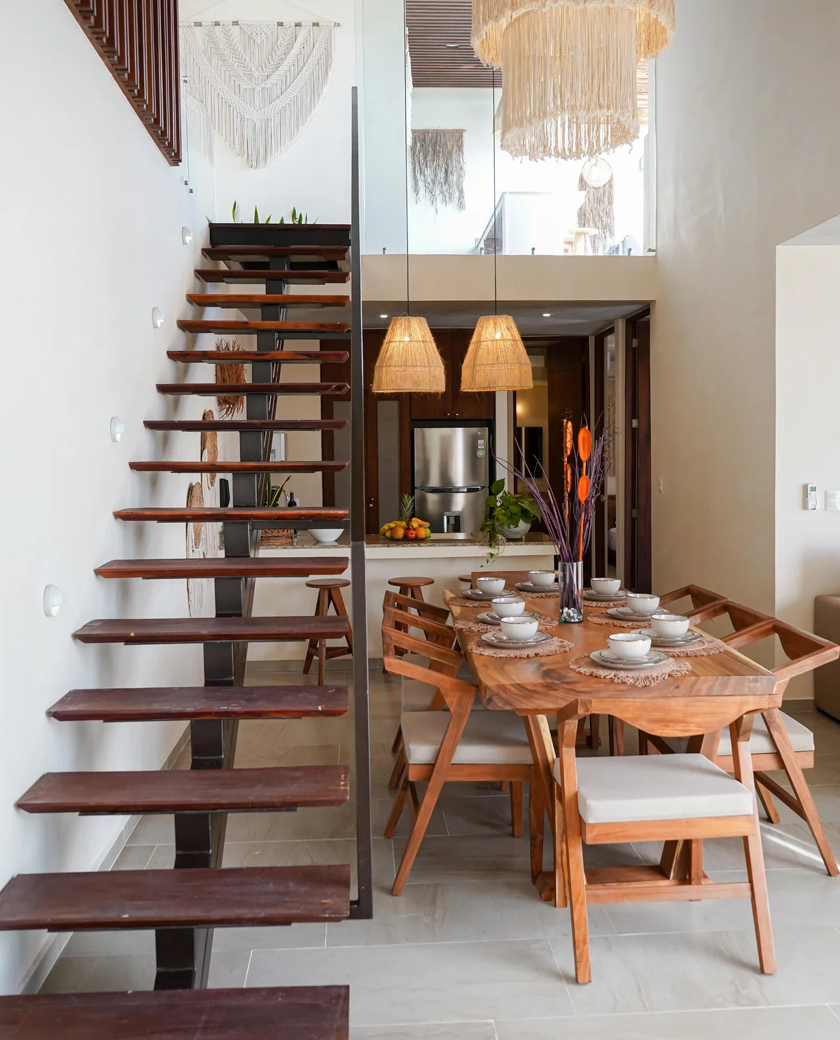 Image of a Dining Area, featuring Floating Staircase and High Ceilings.