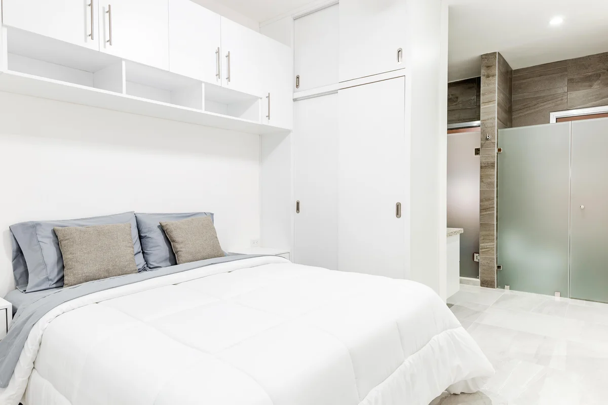 Image of a Modern Bedroom, featuring Ensuite Bathroom and Built-in Cabinetry.