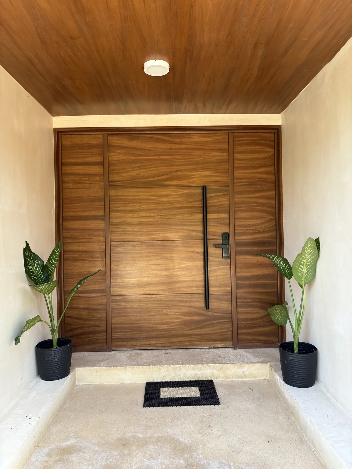 Image of a Oversized Wood Door, featuring Wood Paneled Ceiling and Covered Entryway.