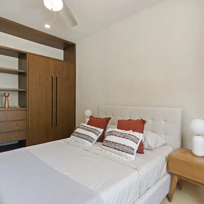 Image of a Bedroom, featuring Built-in Wood Cabinetry and Upholstered Headboard.