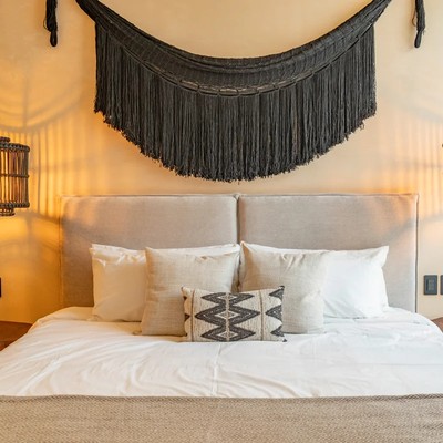 Image of a Bohemian-Chic Bedroom, featuring Woven Pendant Lights and Upholstered Headboard.