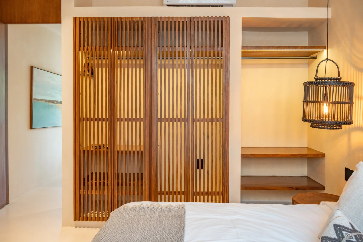 Image of a Bedroom, featuring Wooden Slat Closet and Natural Wood Accents.