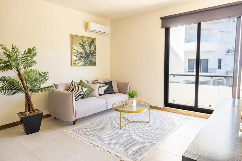 View of Living Room at Mya Black Diamond, showcasing Modern Decor, Natural Light.