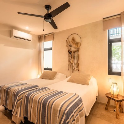 Image of a Guest Bedroom, featuring Twin Beds and Air Conditioning.