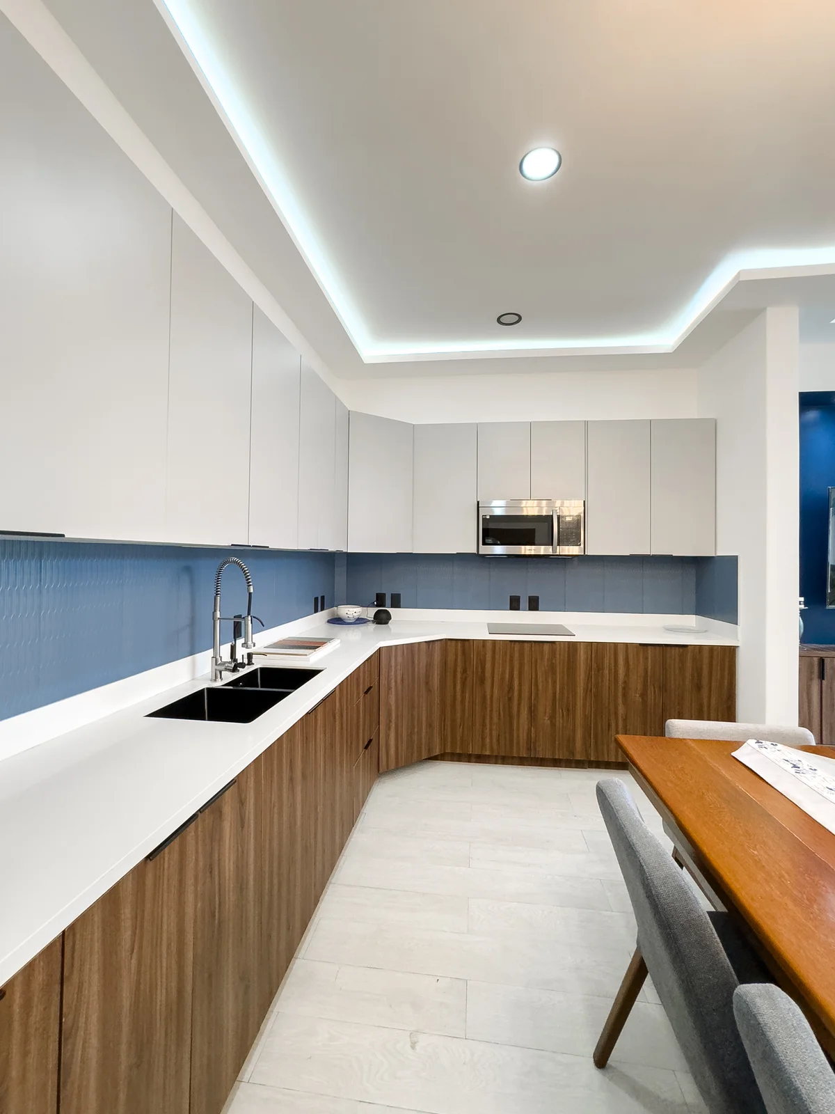 View of Modern Kitchen at Blue Water, showcasing Two-Tone Cabinets, Wood Grain Cabinetry.