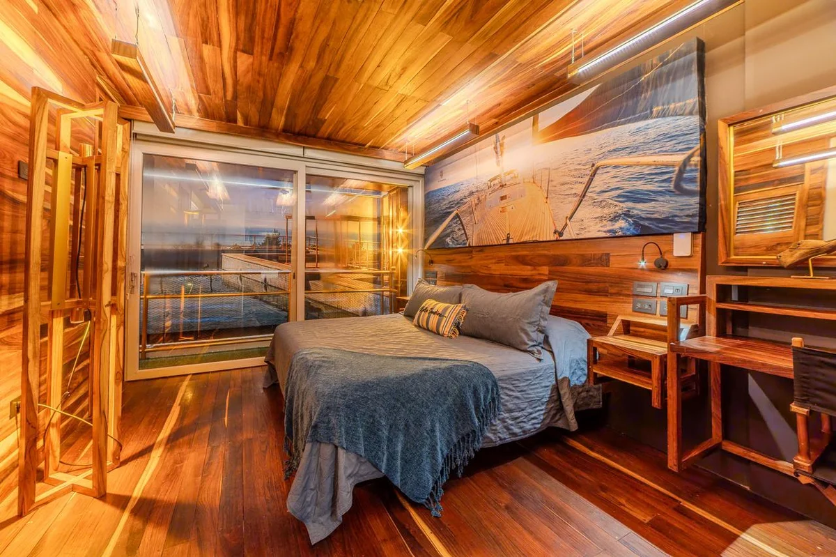 Image of a Wood Paneled Bedroom, featuring Hardwood Floors and Vaulted Wood Ceiling.