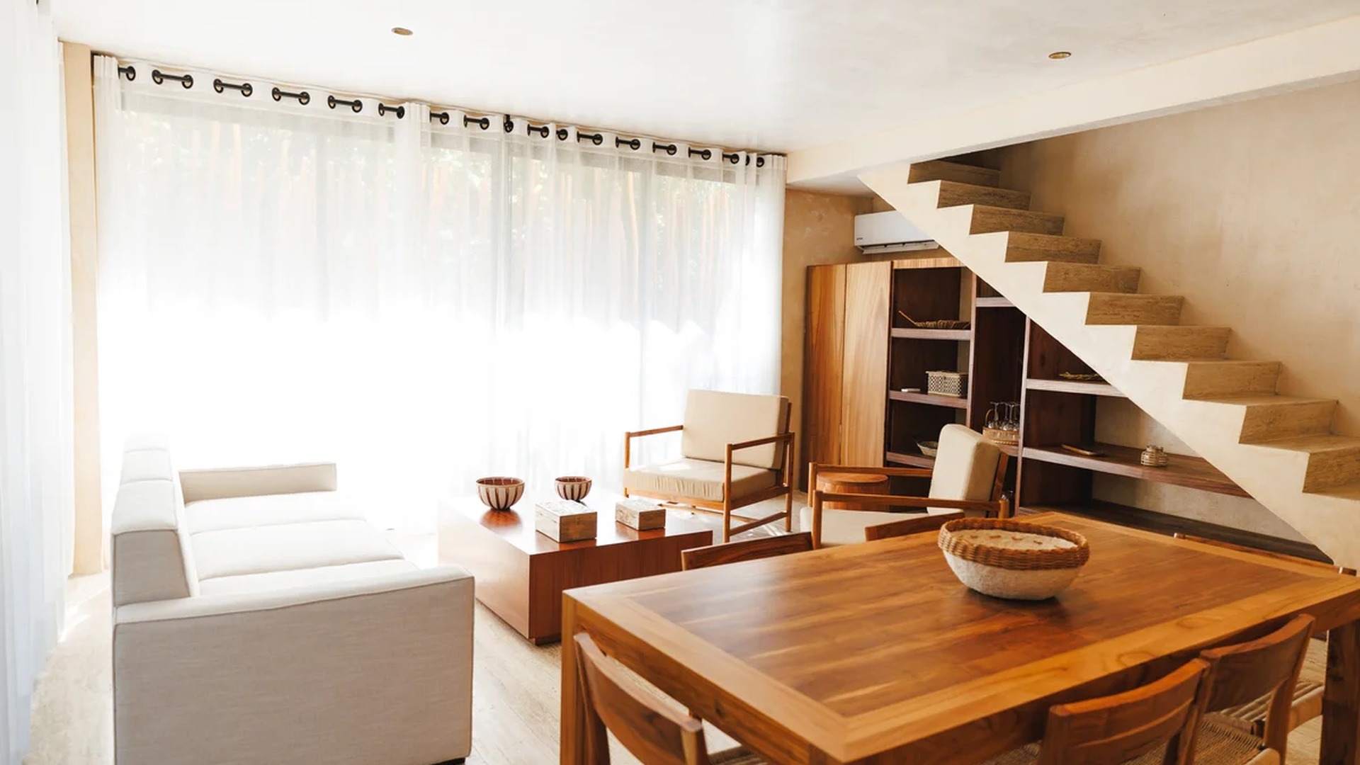 Image of a Open Concept Living, featuring Floating Stone Staircase and Natural Light.