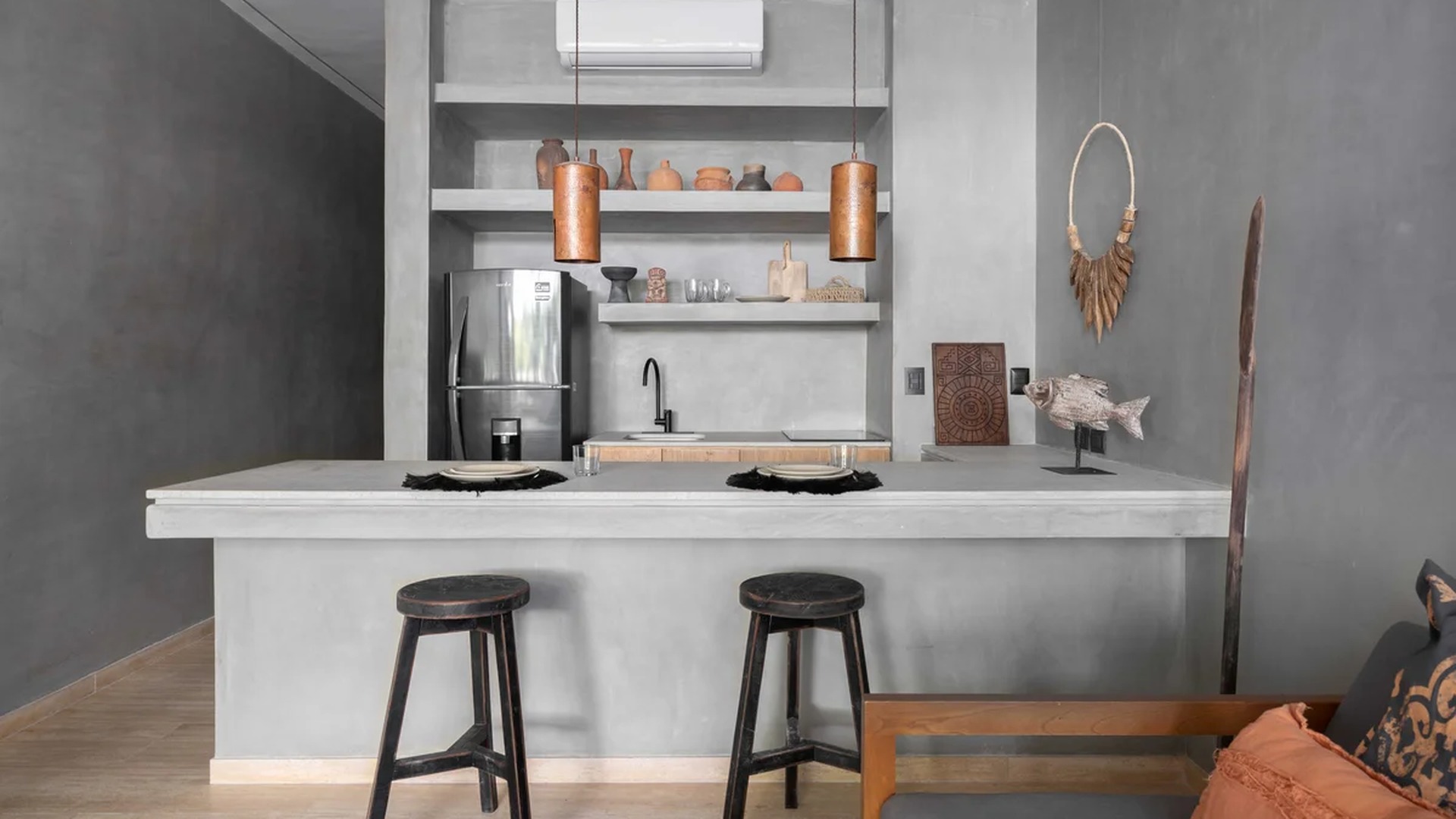 Image of a Kitchenette, featuring Breakfast Bar and Polished Concrete Walls.