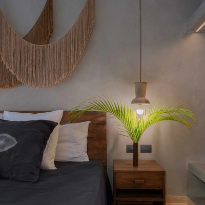 Image of a Bohemian Style Bedroom, featuring Concrete Walls and Wooden Headboard.