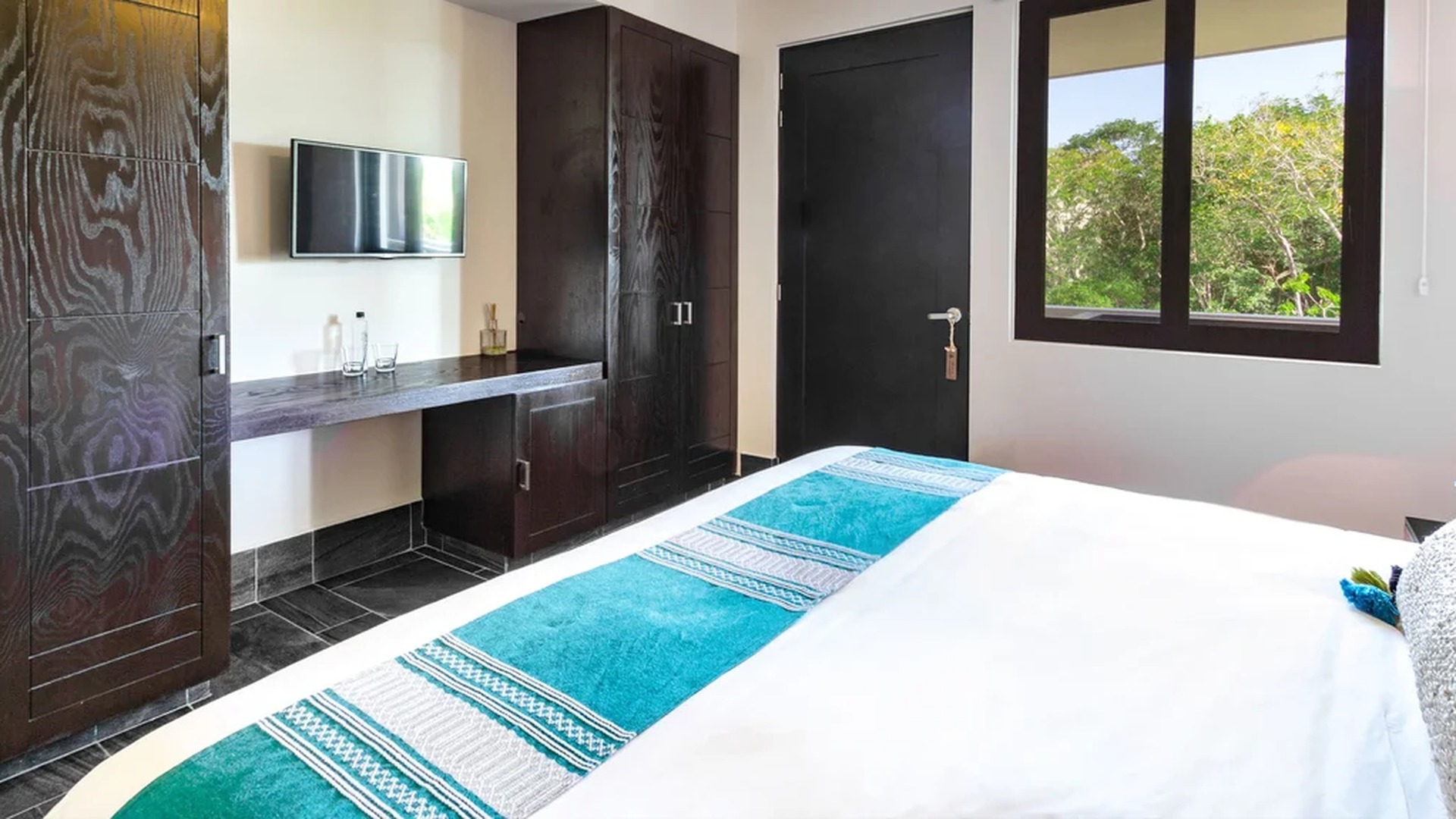 Image of a Bedroom, featuring Dark Wood Cabinetry and Built-in Desk.