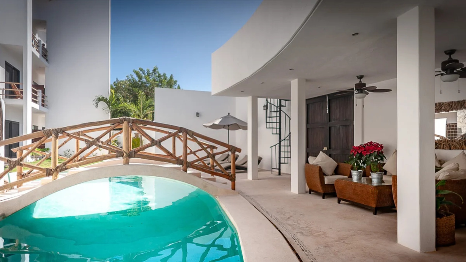 Image of a Resort-Style Pool, featuring Wooden Bridge and Covered Patio.