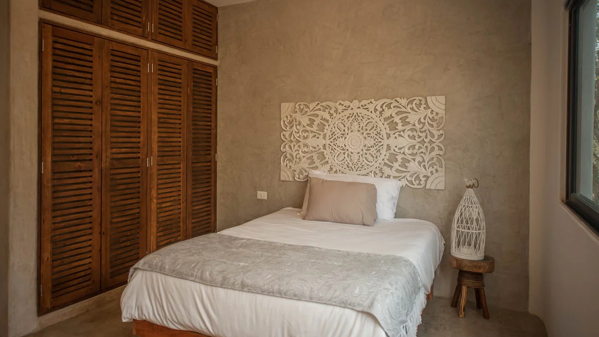 Image of a Bedroom, featuring Concrete Walls and Built-in Wardrobe.