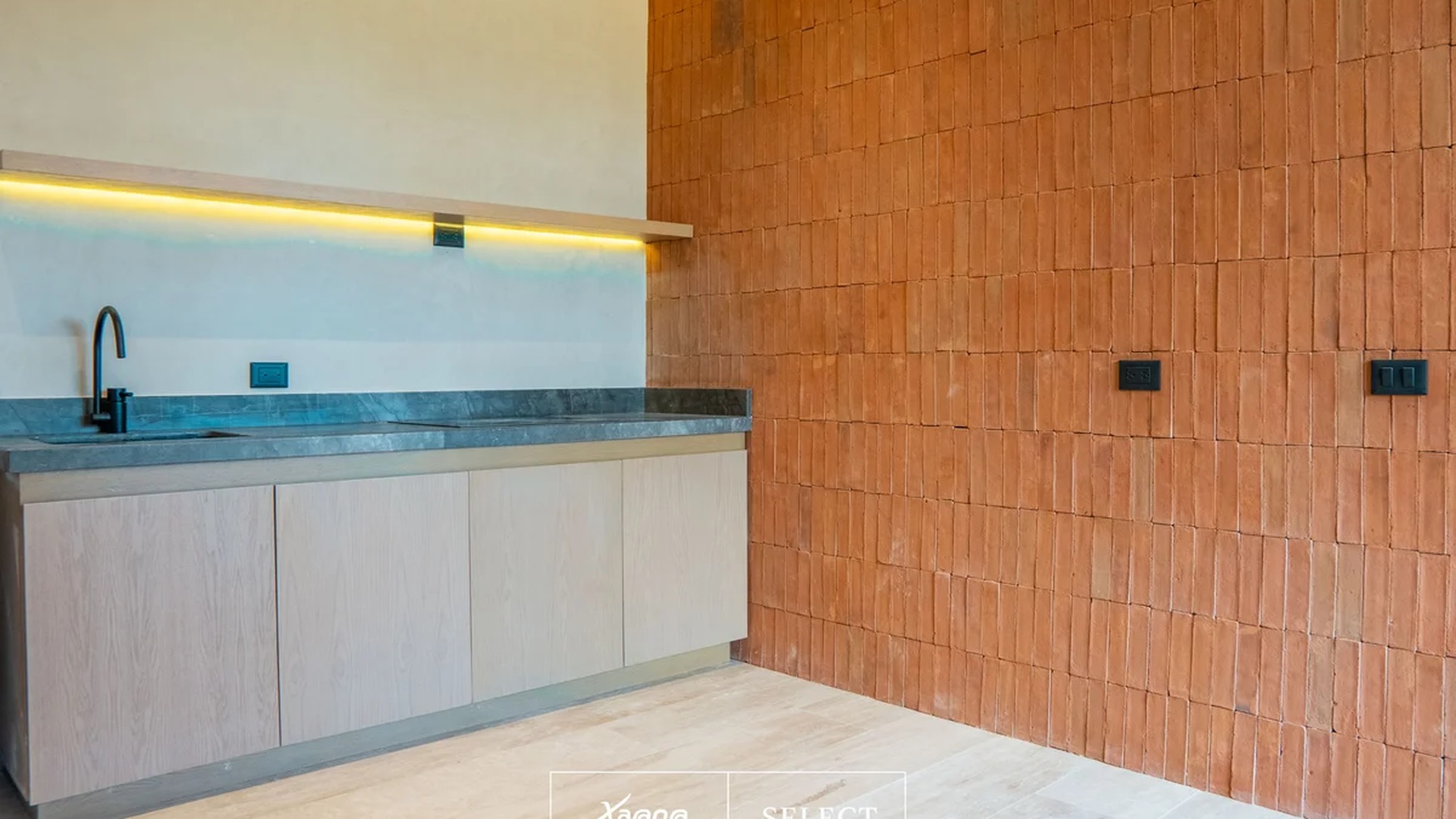 Image of a Modern Kitchenette, featuring Brick Accent Wall and Stone Countertops.