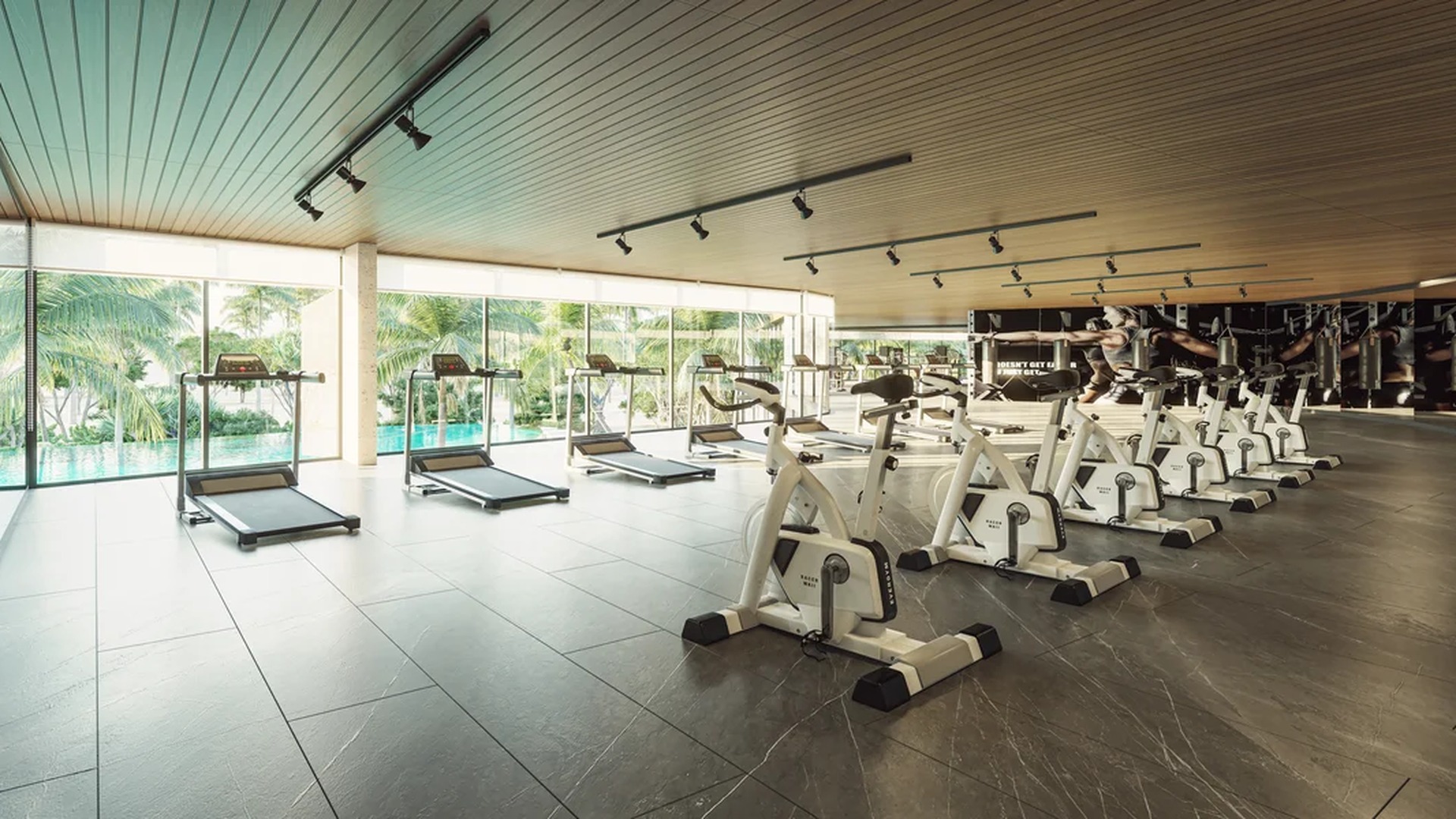 Image of a Fitness Center, featuring Floor-to-Ceiling Windows and Pool View.