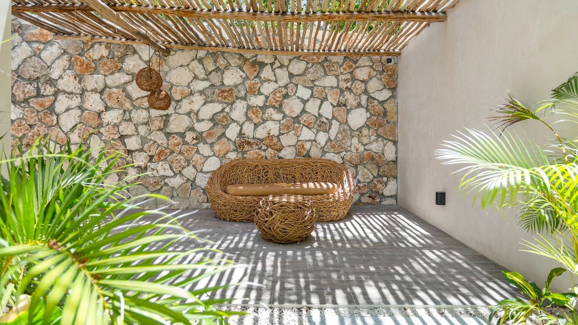 Image of a Covered Patio, featuring Stone Accent Wall and Wooden Pergola.