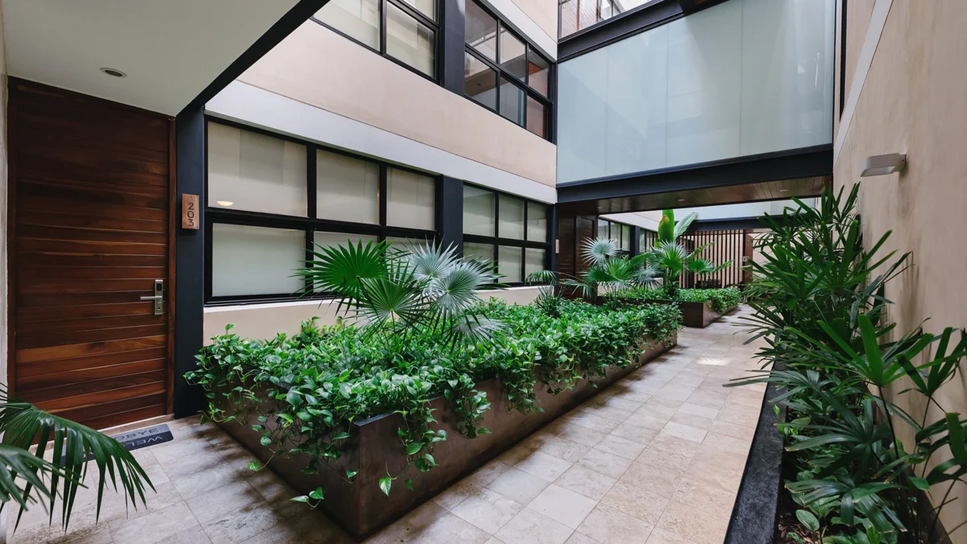Image of a Interior Courtyard, featuring Lush Greenery and Modern Architecture.