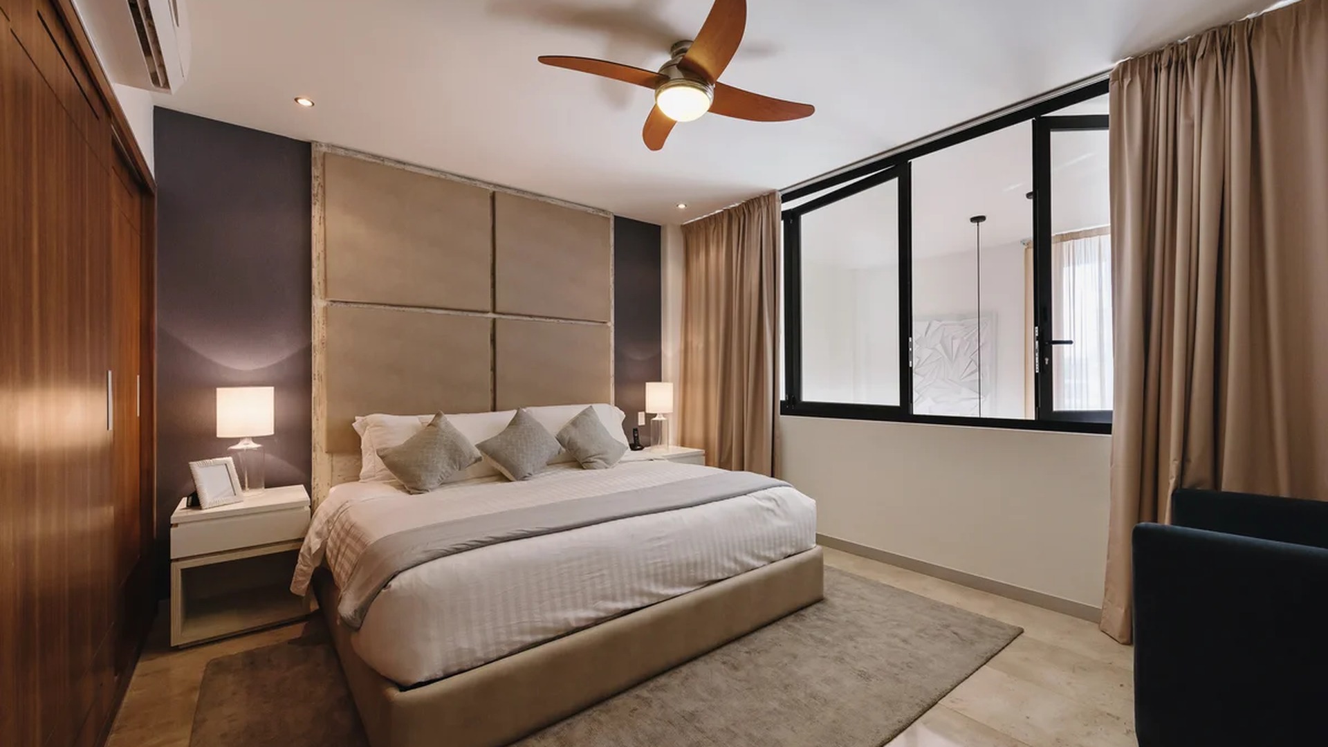 Image of a Modern Bedroom, featuring Upholstered Headboard and Accent Wall.