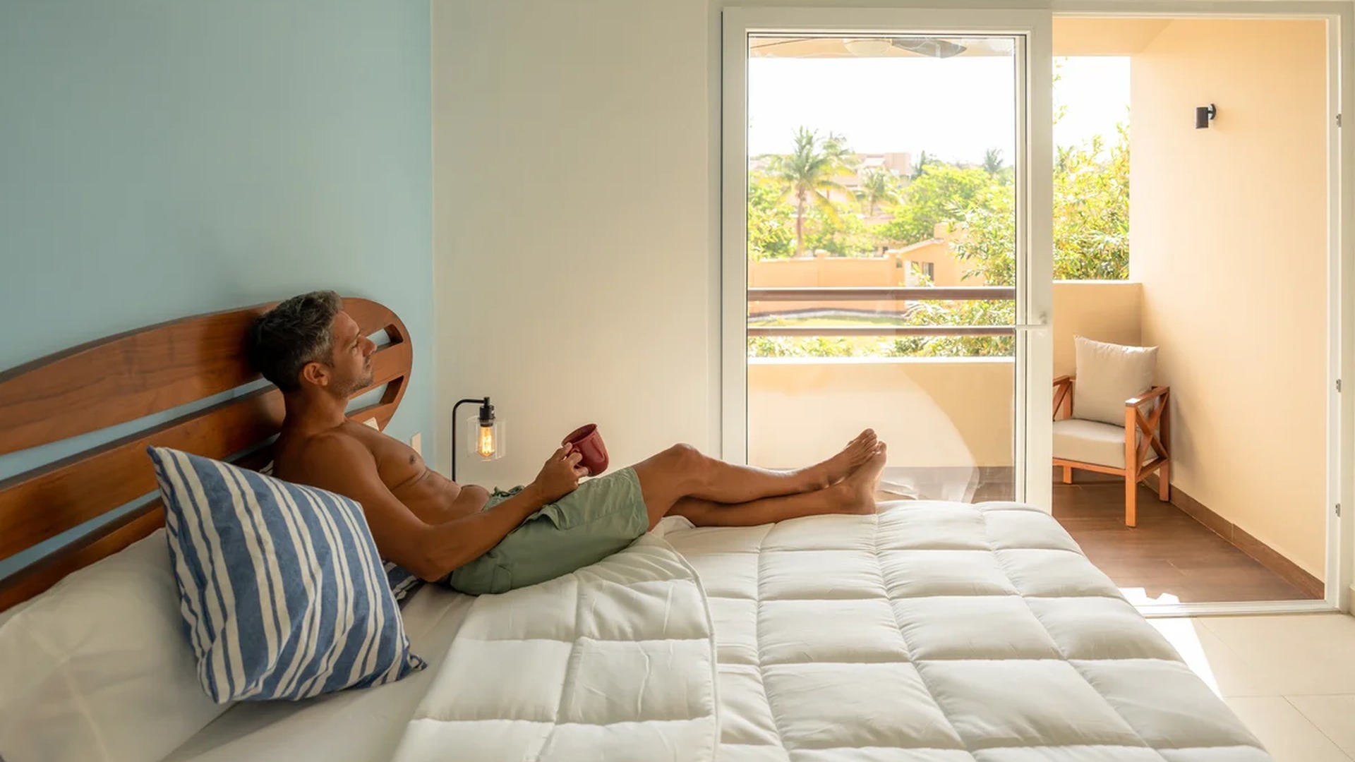 Image of a Bright Bedroom, featuring Private Balcony and Sliding Glass Doors.
