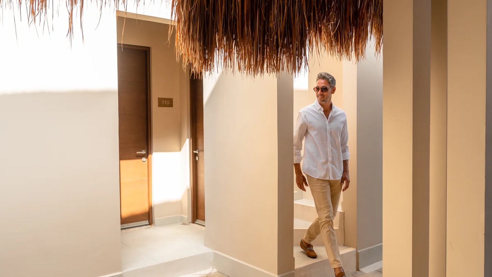 Image of a Private Entrance, featuring Thatch Roof and Stone Paver Patio.