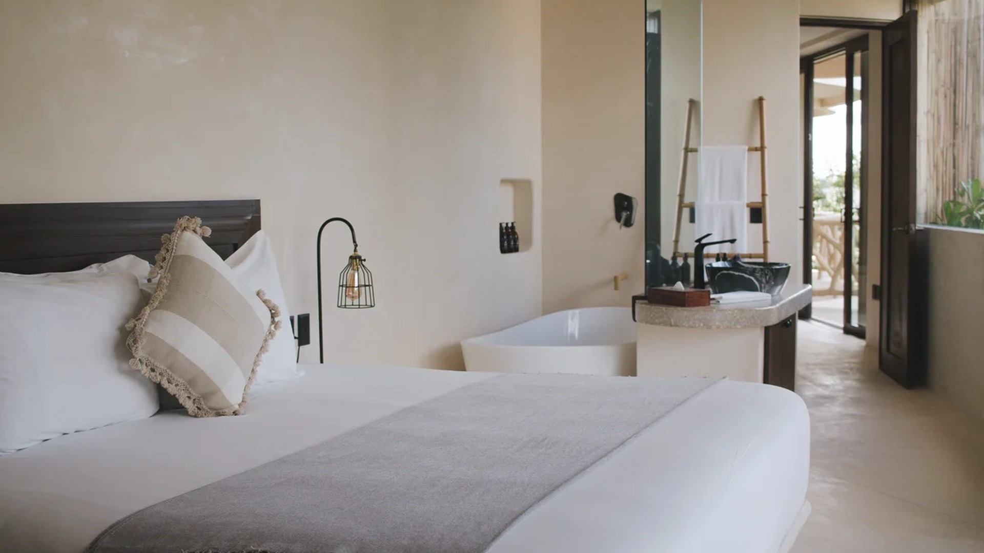 Image of a Bedroom Suite, featuring Open-Concept Bathroom and Freestanding Bathtub.