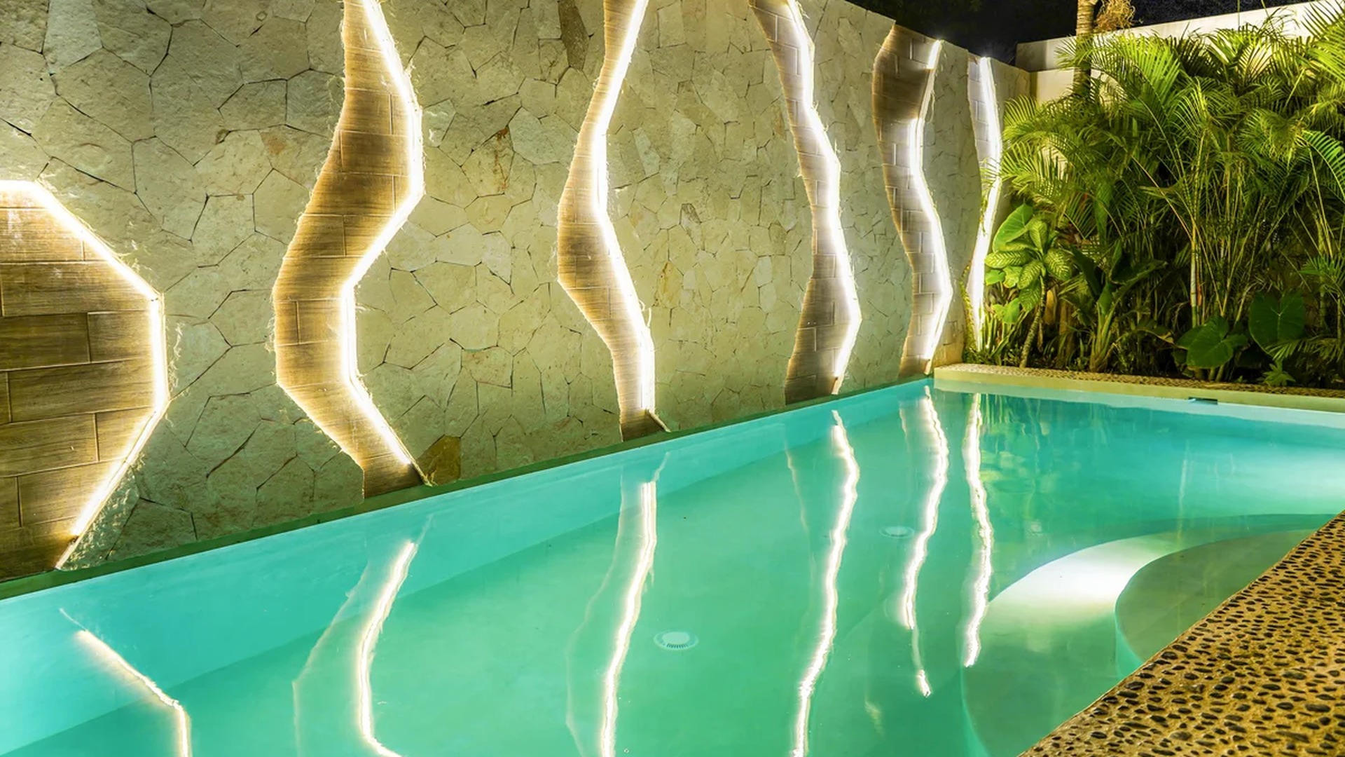 Image of a Private Pool, featuring Stone Accent Wall and Custom Lighting.