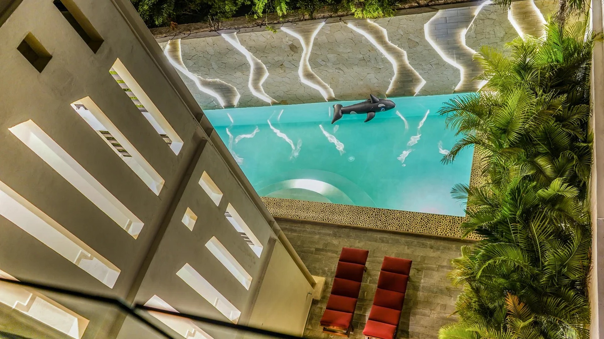 Image of a Courtyard Pool, featuring Custom Accent Lighting and Stone Pool Deck.