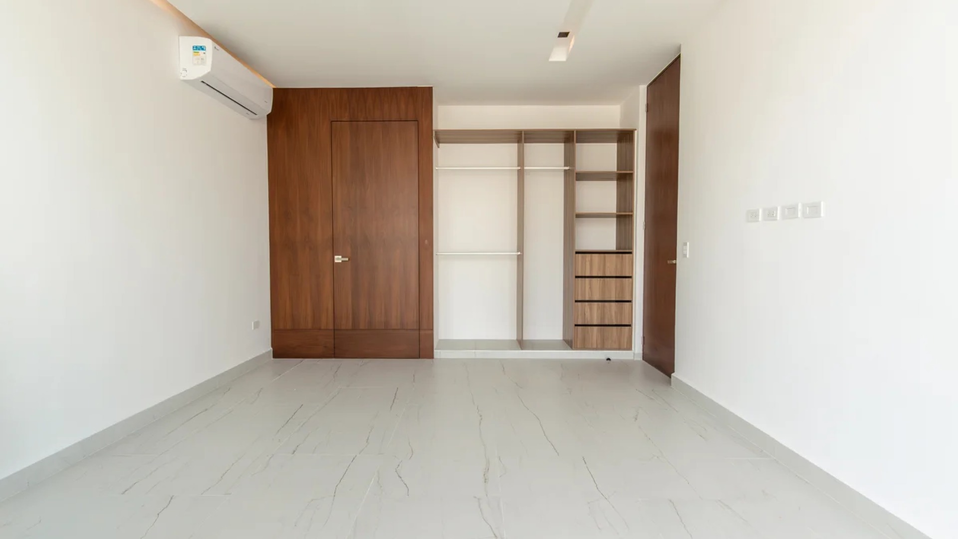 Image of a Walk-in Closet, featuring Spacious Bedroom and Built-in Wood Cabinetry.
