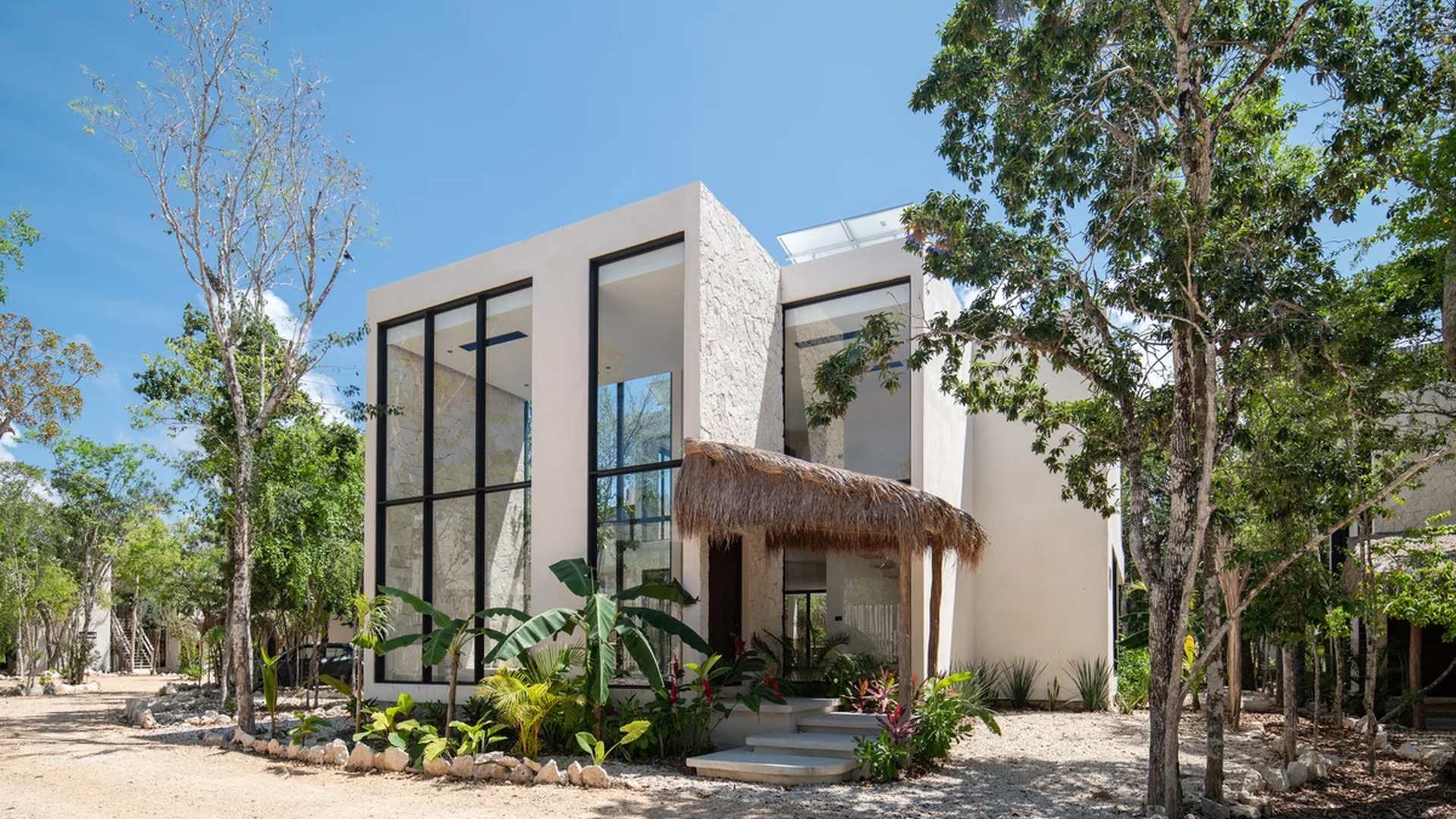 Image of a Modern Architecture, featuring Floor-to-Ceiling Windows and Stone Accent Walls.