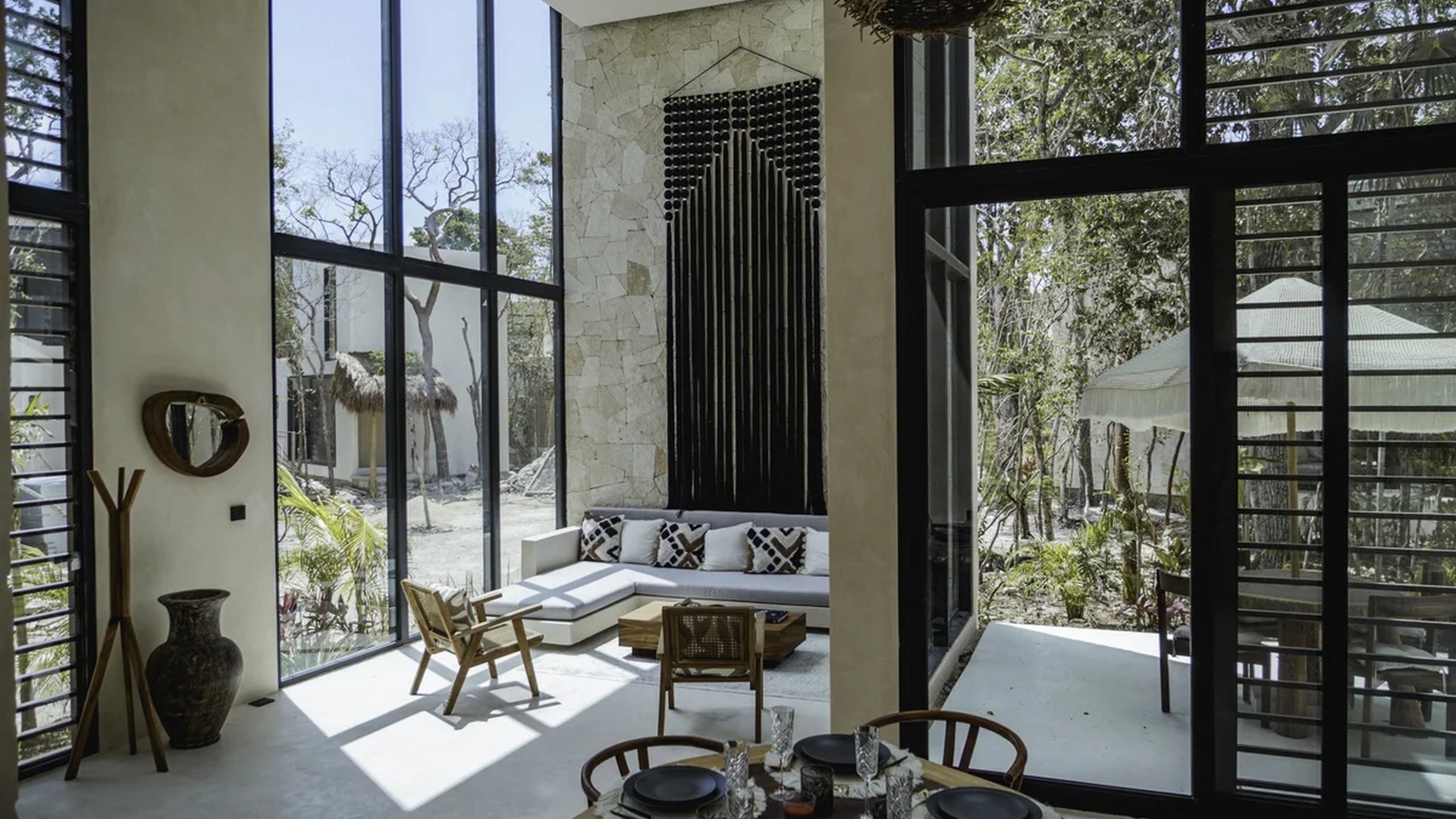 Image of a Double-Height Ceilings, featuring Floor-to-Ceiling Windows and Stone Accent Wall.